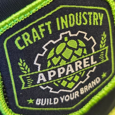 Close-up of a navy and lime green woven patch